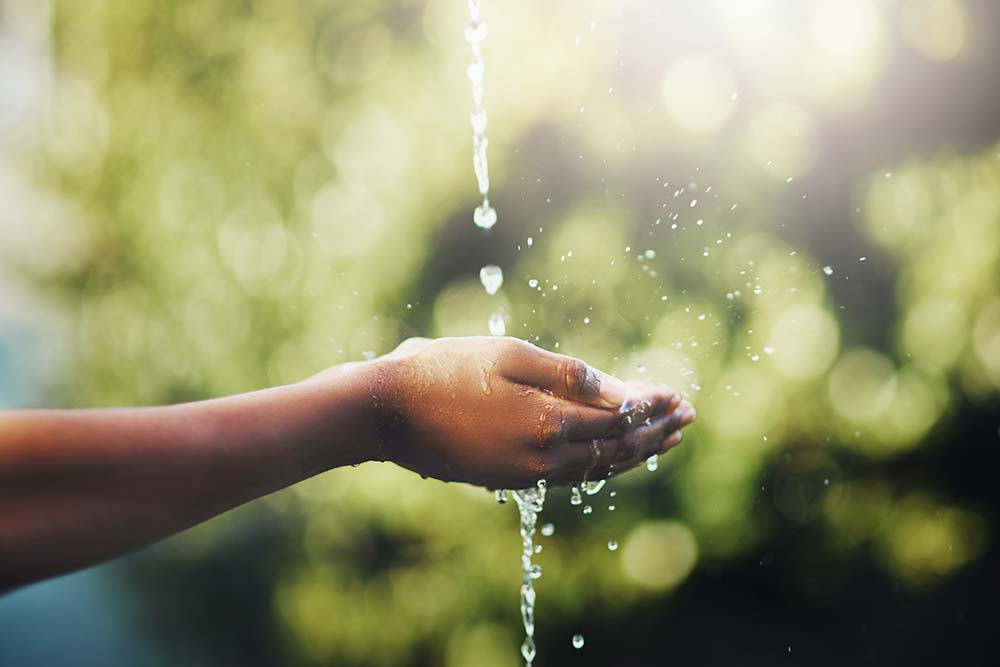 Hands catching pouring water
